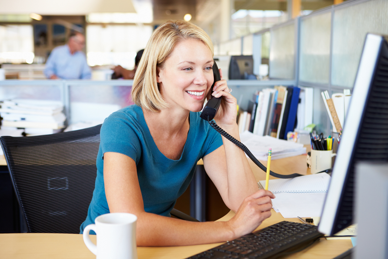 Modern office with woman on phone and computer